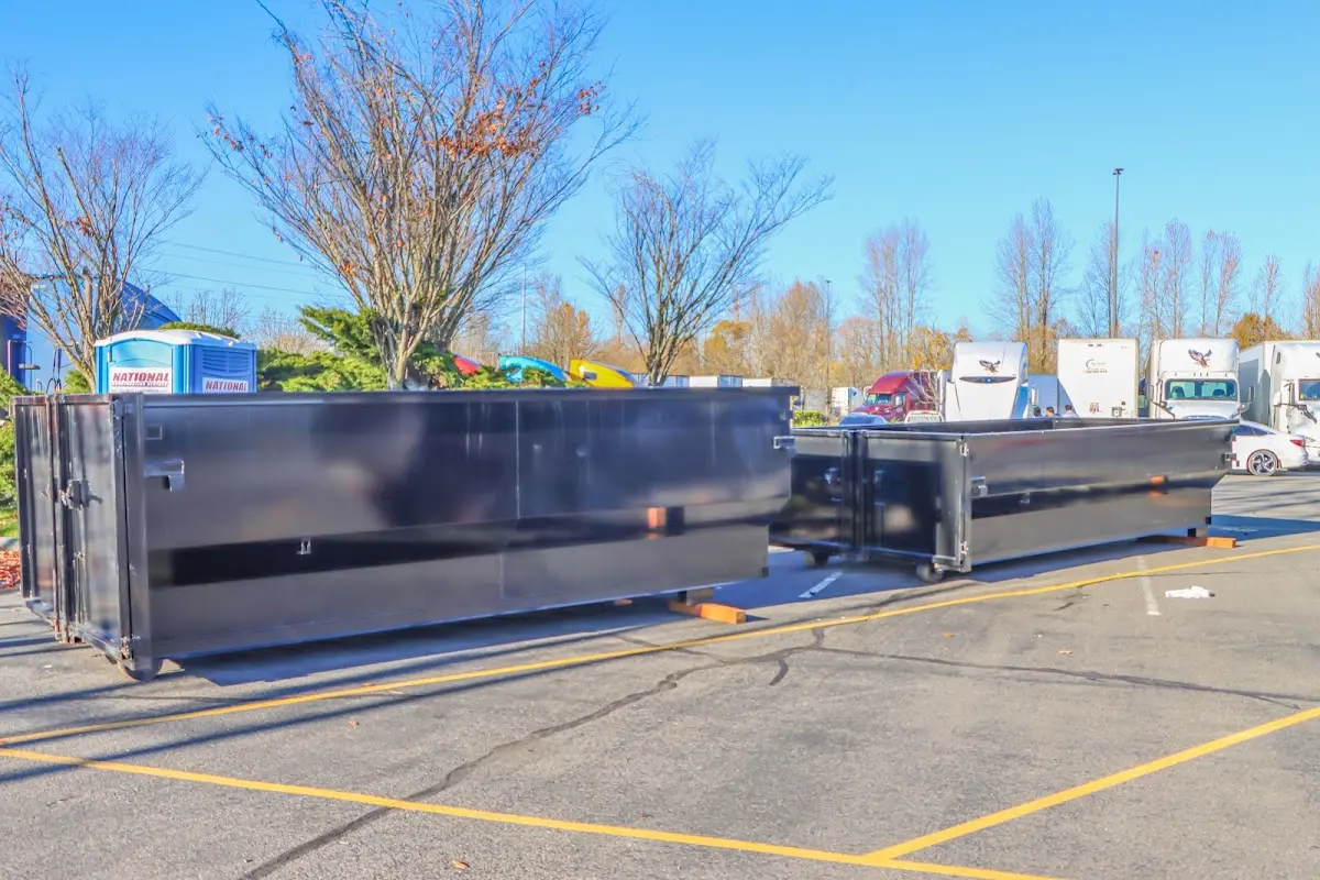 Professional dumpster rental service with roll-off container on residential driveway in Bay City